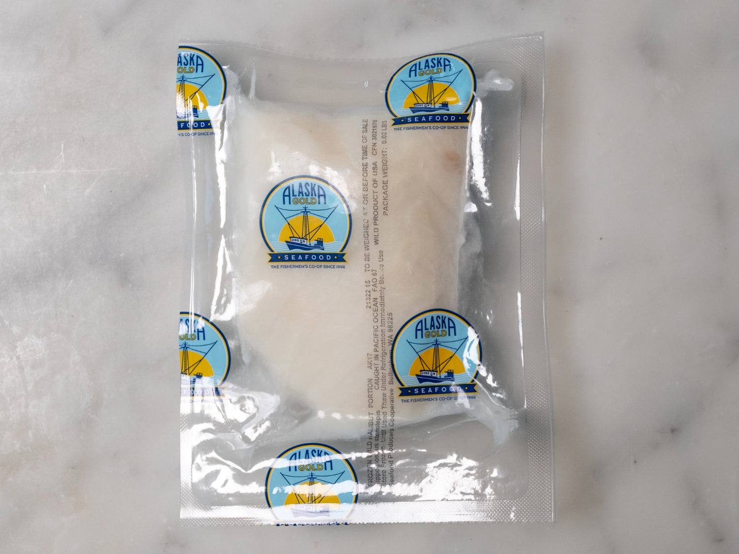 halibut filet vacuum sealed in proprietor's plastic packaging with logos visible