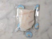 backside of halibut filet vacuum sealed in proprietor's plastic packaging