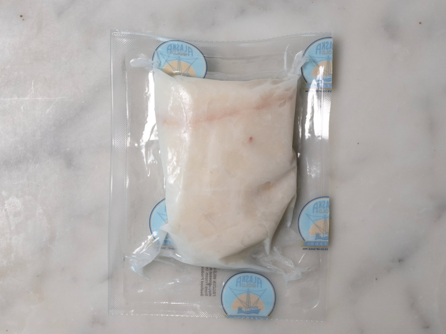 backside of halibut filet vacuum sealed in proprietor's plastic packaging
